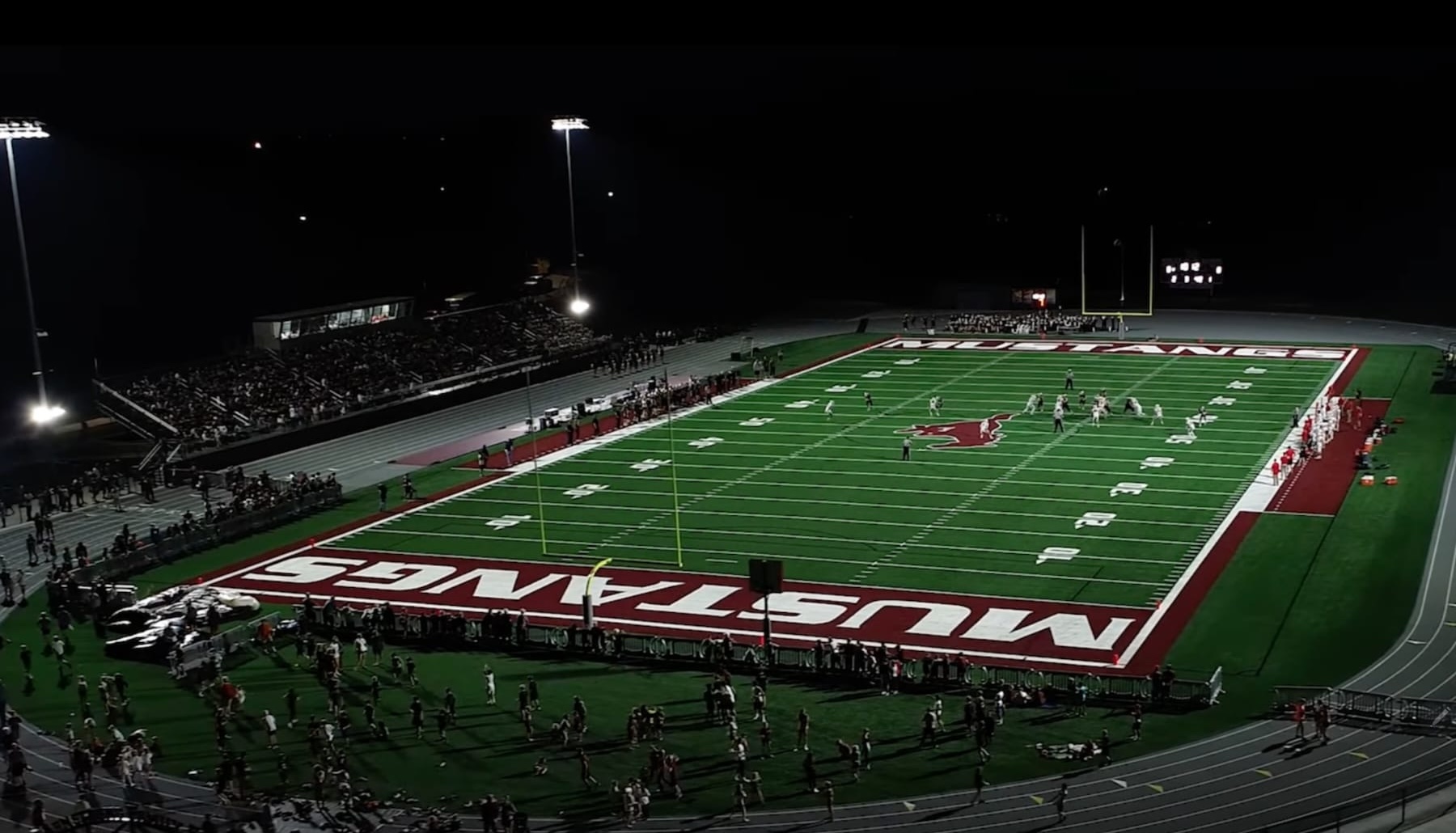 Players running onto a football field